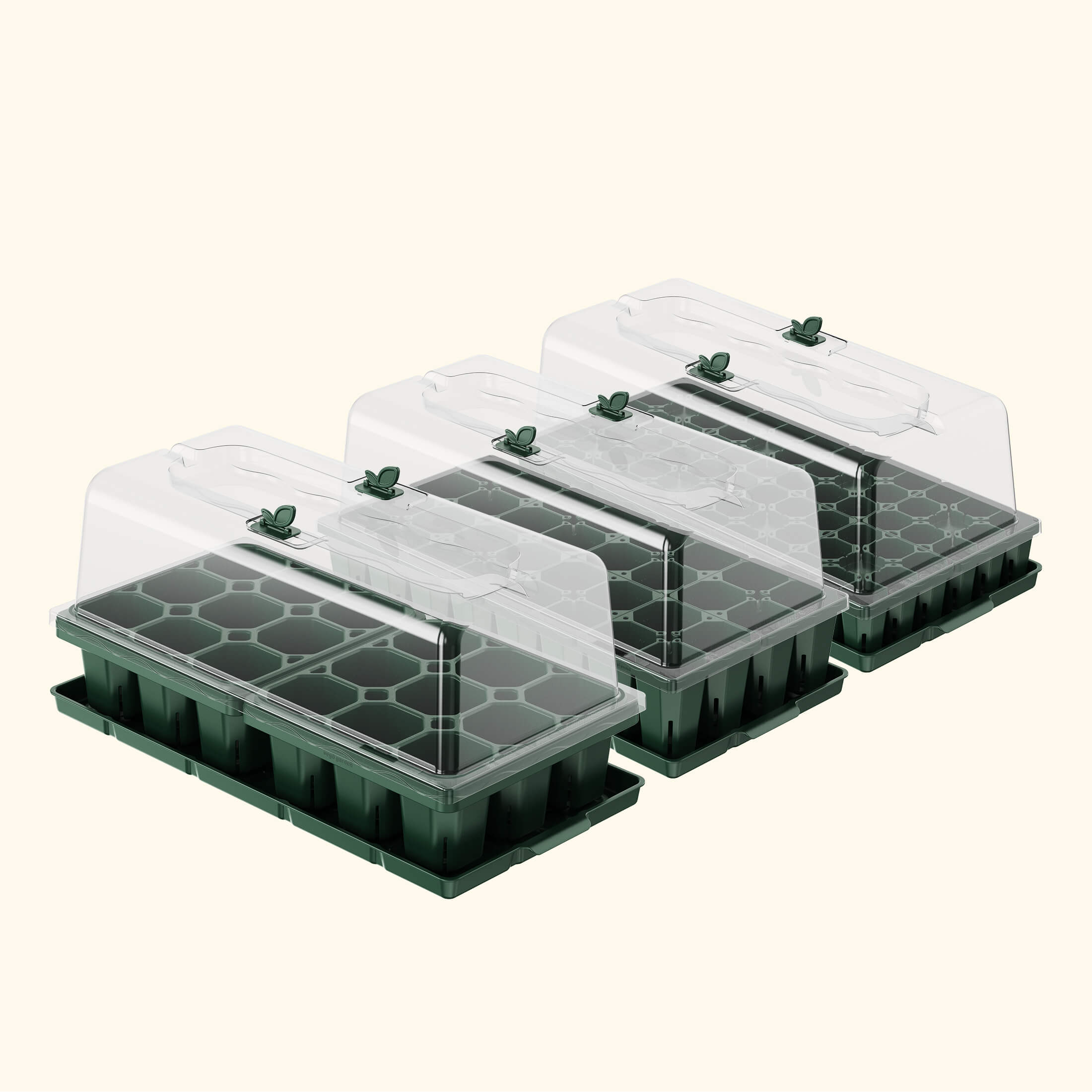 Set of green seedling trays with clear lids on a white background